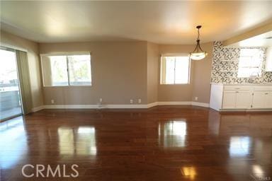 interior space featuring plenty of natural light and dark wood-type flooring