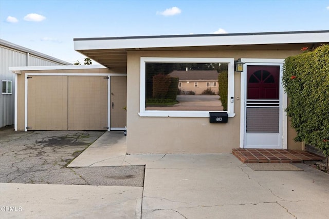 doorway to property featuring a carport