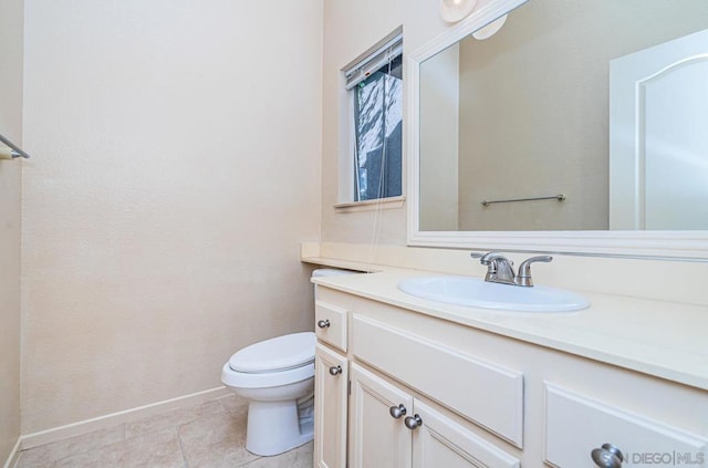 bathroom with vanity, toilet, and tile patterned floors