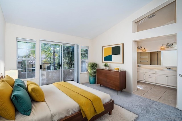 bedroom with access to outside, light tile patterned flooring, sink, vaulted ceiling, and ensuite bathroom