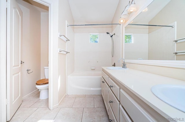 full bathroom with tiled shower / bath, vanity, toilet, and tile patterned floors