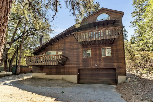 exterior space featuring a balcony and a garage