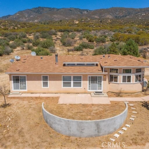 rear view of house featuring a mountain view