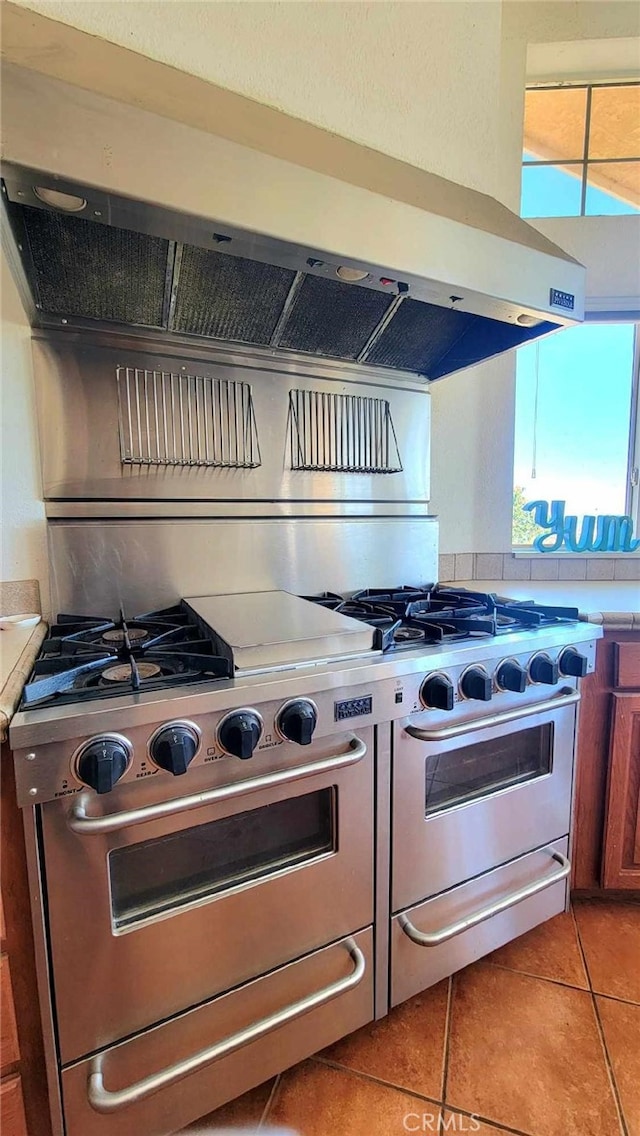 kitchen featuring ventilation hood and light tile patterned floors