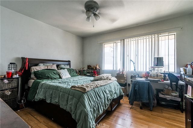 bedroom with ceiling fan and hardwood / wood-style flooring