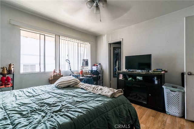 bedroom featuring light wood-type flooring and ceiling fan