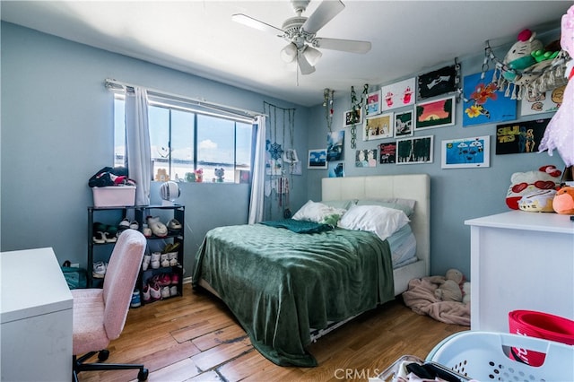 bedroom featuring light hardwood / wood-style flooring and ceiling fan