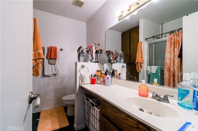 bathroom featuring vanity, toilet, and a shower with curtain