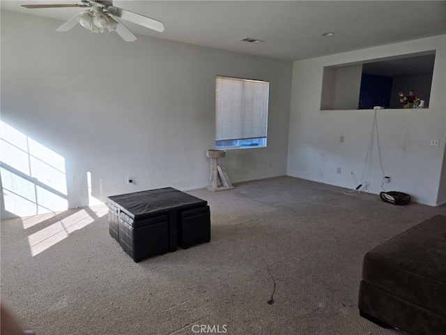 unfurnished living room featuring carpet and ceiling fan