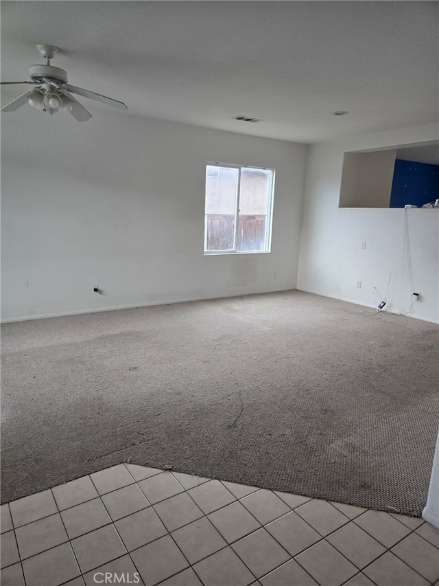 spare room with light carpet, ceiling fan, and visible vents