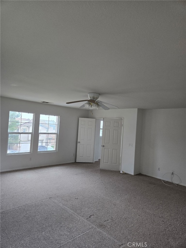 interior space featuring visible vents and a ceiling fan