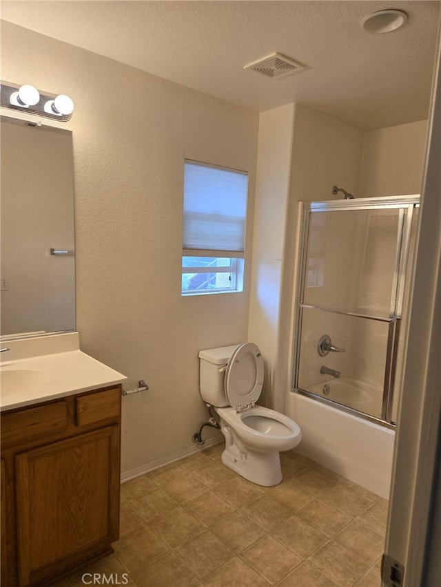 full bathroom with visible vents, toilet, enclosed tub / shower combo, a textured ceiling, and vanity