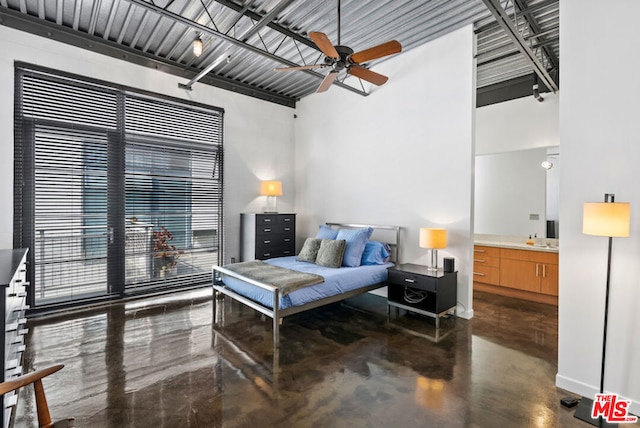 bedroom featuring a high ceiling, ensuite bathroom, and ceiling fan