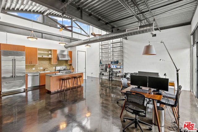 office space with ceiling fan, sink, and high vaulted ceiling