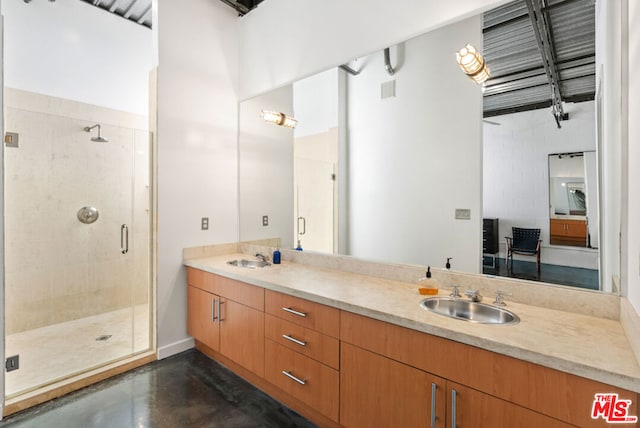 bathroom with vanity, an enclosed shower, and concrete floors