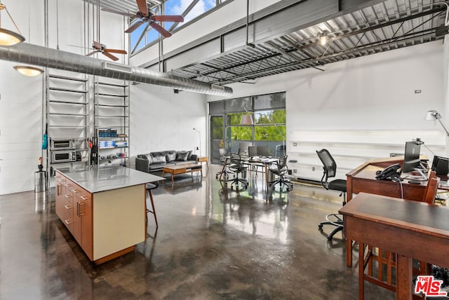 interior space with ceiling fan