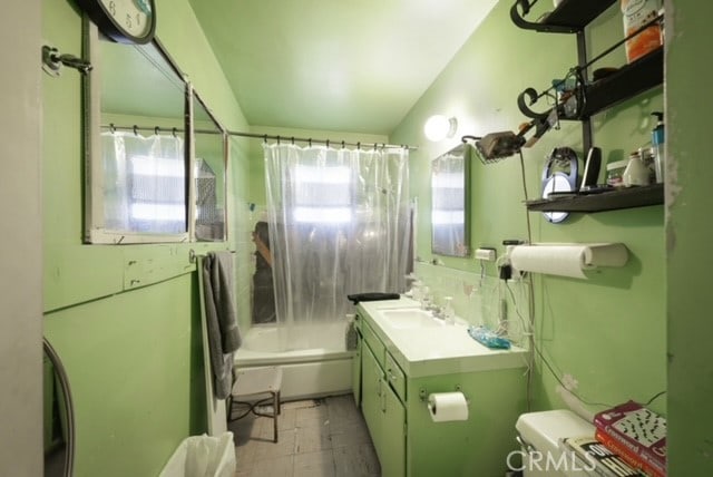 full bathroom featuring vanity, shower / tub combo, and toilet