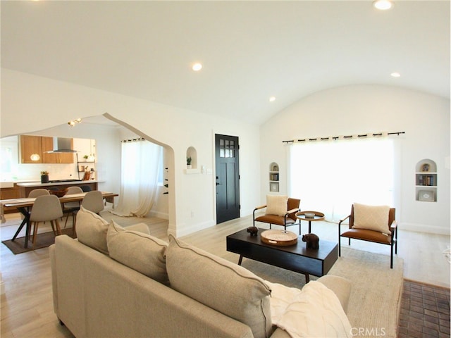 living room with lofted ceiling and light hardwood / wood-style flooring