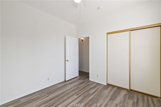 unfurnished bedroom with light wood-type flooring and a closet