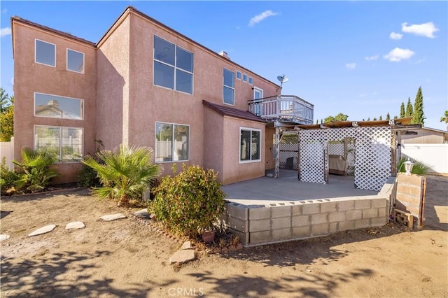 back of property with a balcony