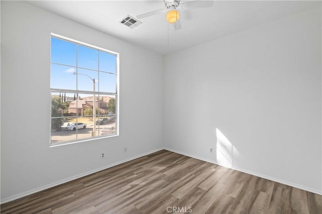 spare room featuring wood-type flooring and ceiling fan