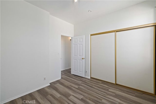 unfurnished bedroom with a closet and light wood-type flooring