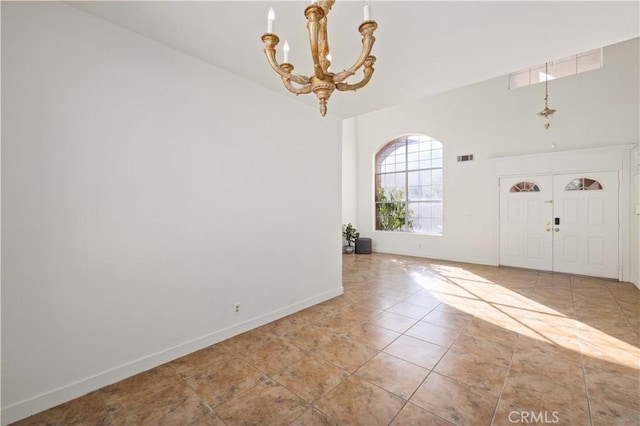 entrance foyer featuring light tile patterned floors and an inviting chandelier