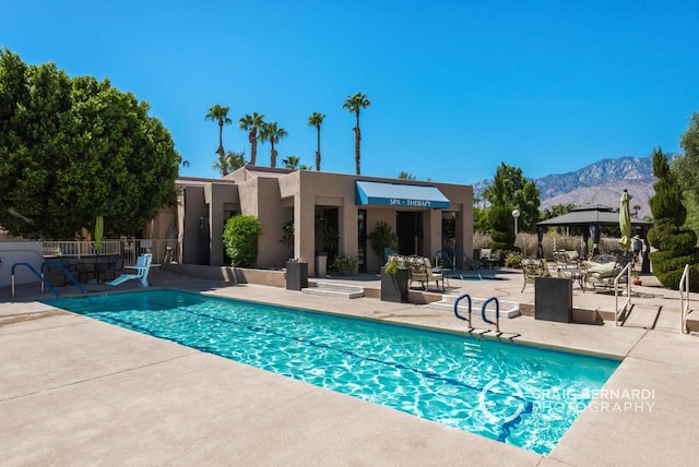 view of pool with a mountain view, a gazebo, and a patio area