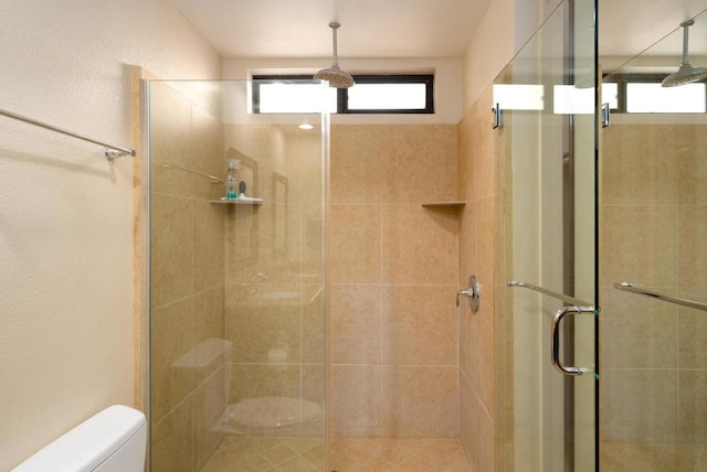 bathroom featuring toilet and walk in shower