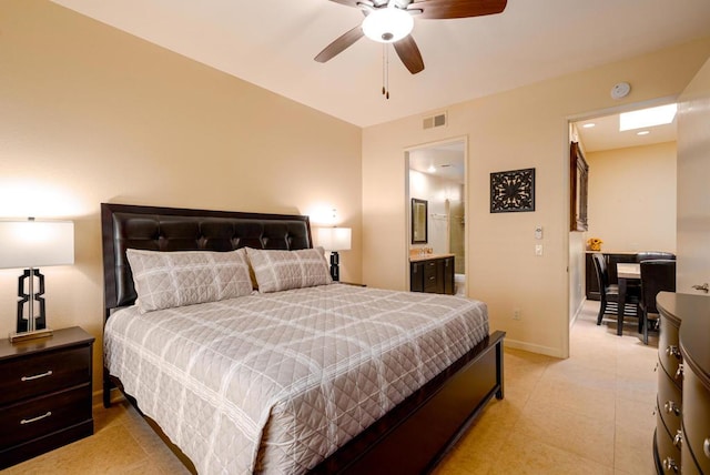 bedroom with ensuite bath and ceiling fan