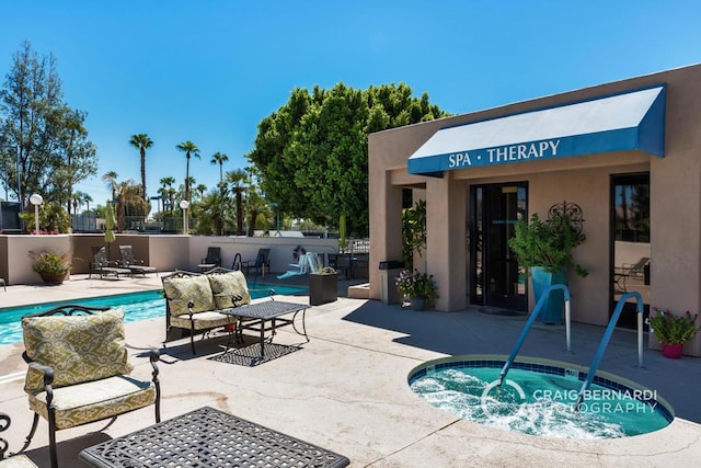 view of swimming pool featuring a hot tub