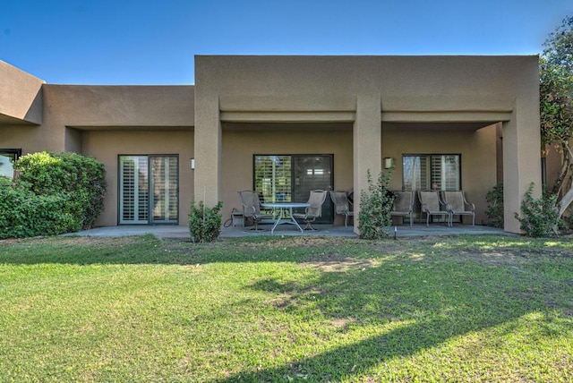 rear view of property with a patio area and a yard