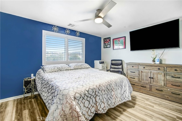 bedroom with light wood-type flooring and ceiling fan