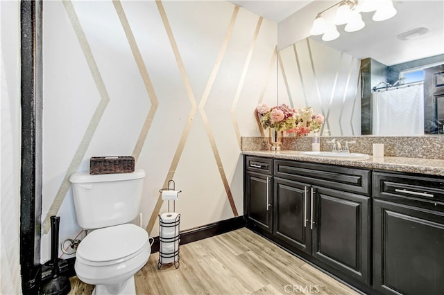 bathroom featuring a shower with shower curtain, vanity, hardwood / wood-style floors, and toilet