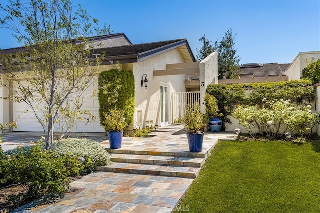 view of front of property featuring a garage and a front lawn