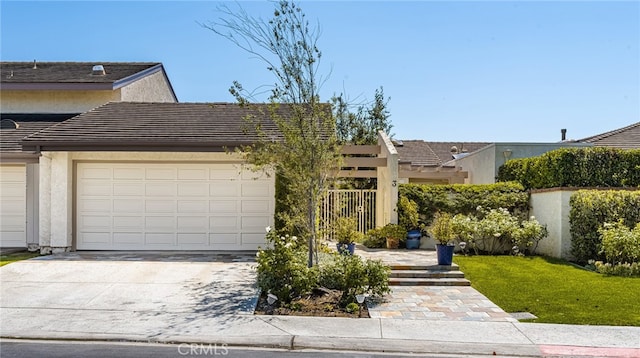 view of front of home with a front yard and a garage