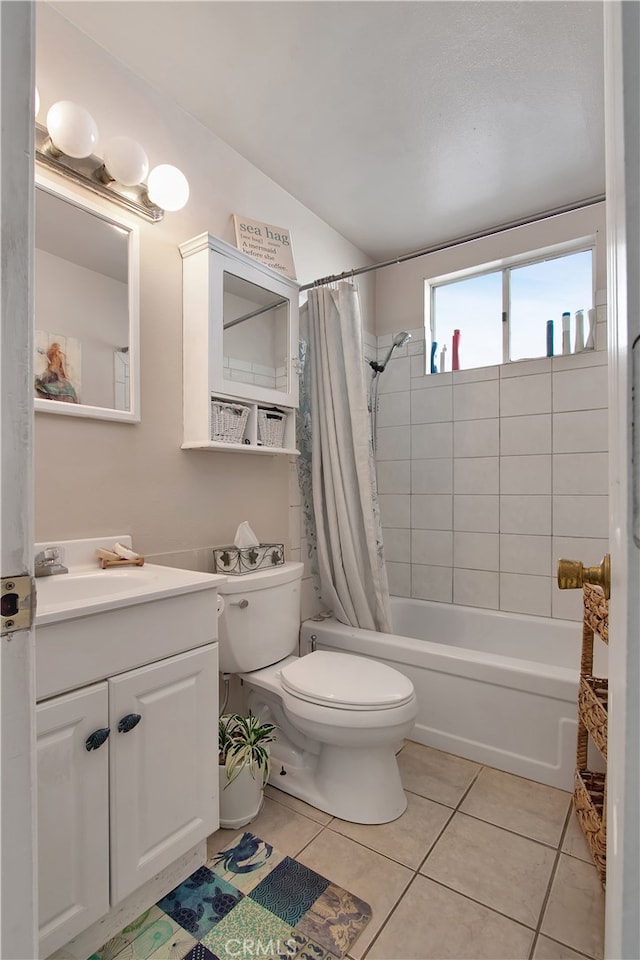 full bathroom featuring vanity, shower / bath combo with shower curtain, toilet, and tile patterned floors