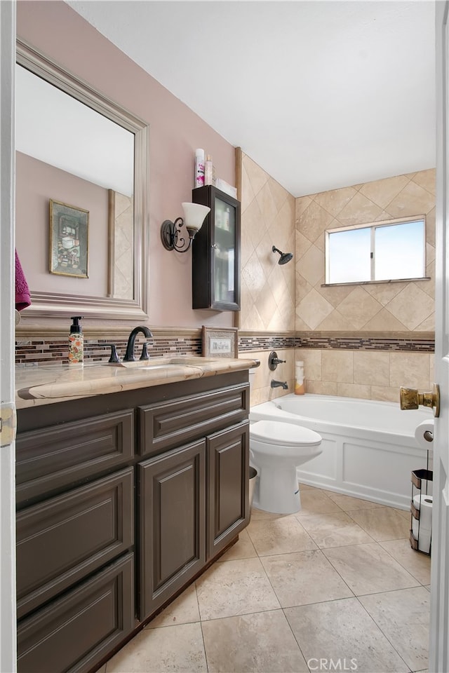 bathroom with vanity, tile walls, tile patterned flooring, and toilet