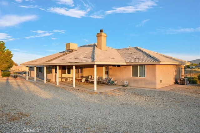 back of property with a patio and central AC unit