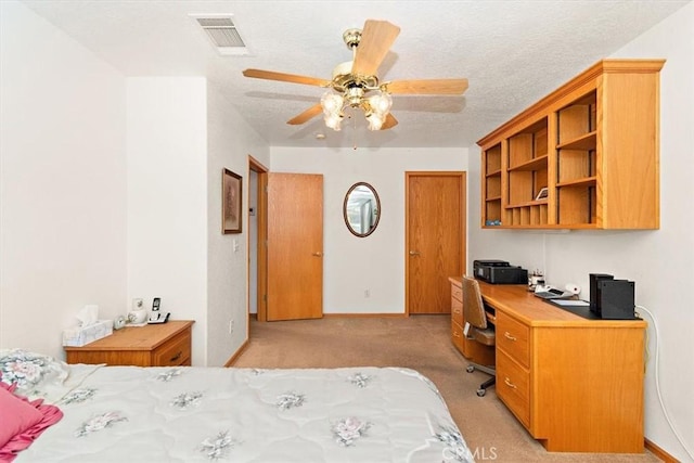 bedroom featuring a textured ceiling, a ceiling fan, visible vents, light carpet, and baseboards