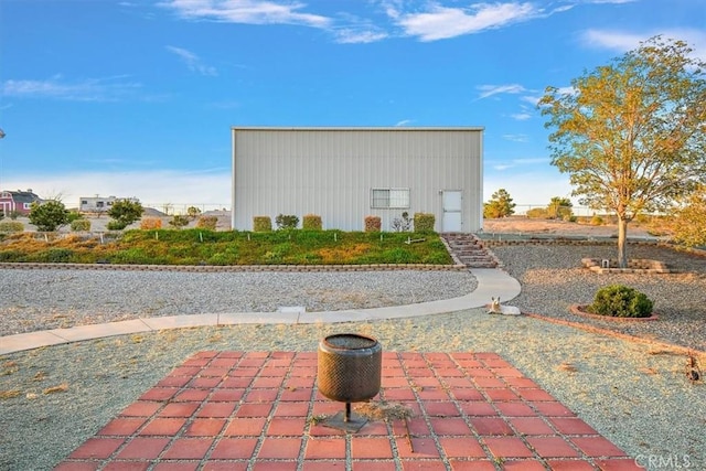 rear view of property with an outbuilding