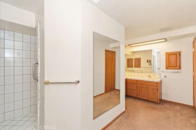 bathroom with vanity and an enclosed shower