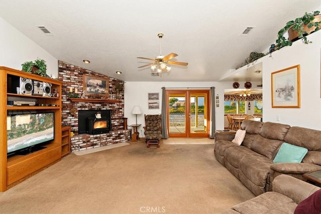 carpeted living area featuring visible vents, ceiling fan, and vaulted ceiling