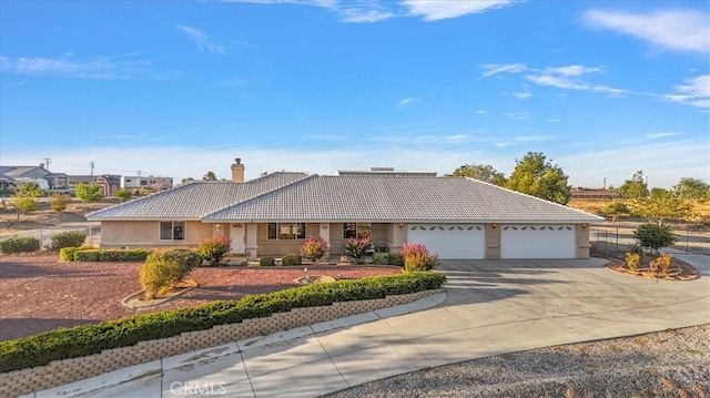 ranch-style house featuring a garage and covered porch