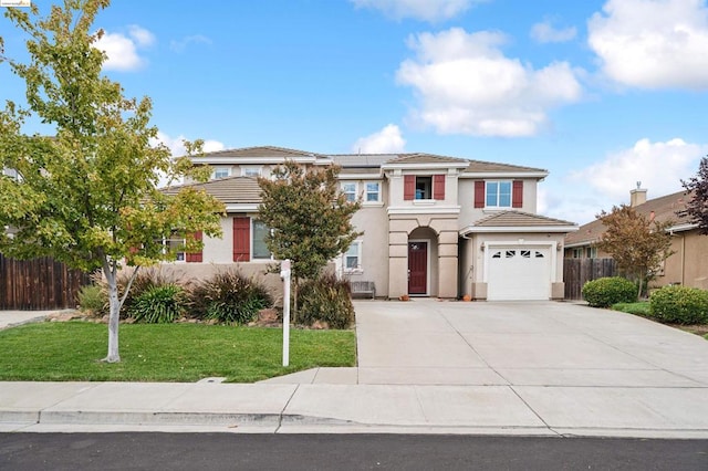 view of front of home featuring a garage and a front lawn