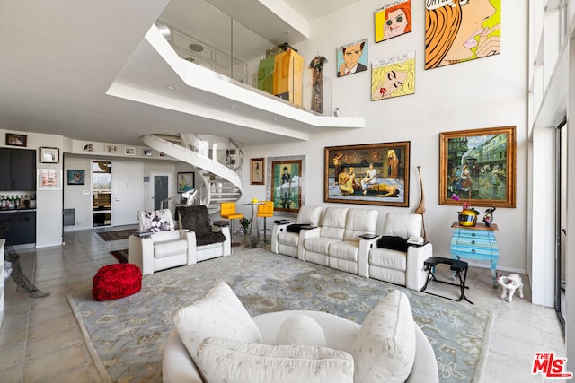 tiled living room featuring a high ceiling