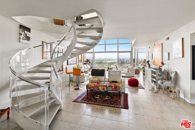 living room featuring expansive windows and light tile patterned floors