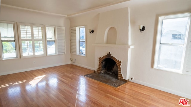 unfurnished living room featuring light hardwood / wood-style floors and a fireplace