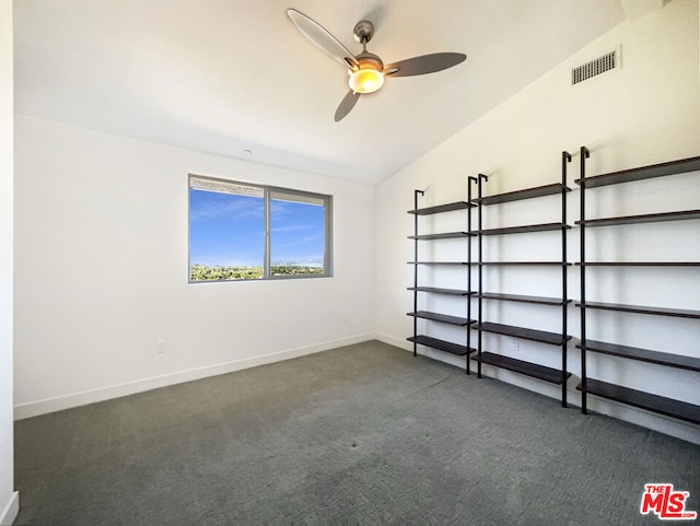 carpeted empty room featuring ceiling fan and vaulted ceiling