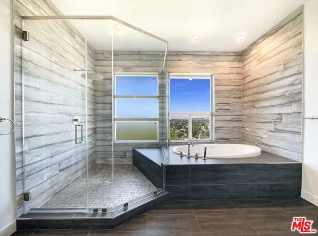 bathroom with tile patterned flooring and separate shower and tub